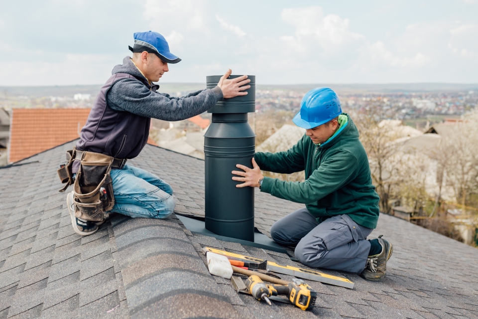 Workers installing chimney